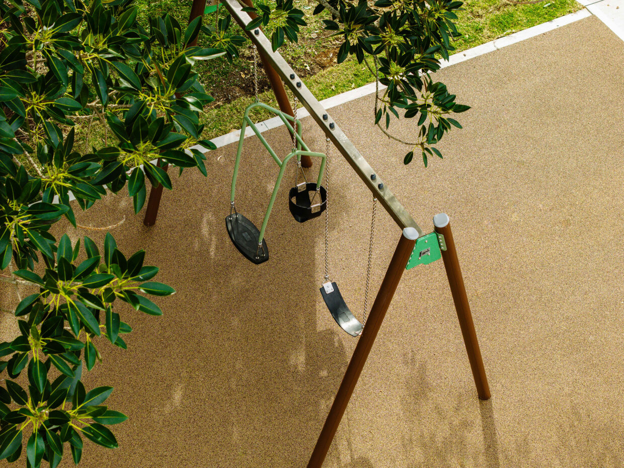 Aerial view of the Connect double bay swing beneath trees at Sunray Crescent